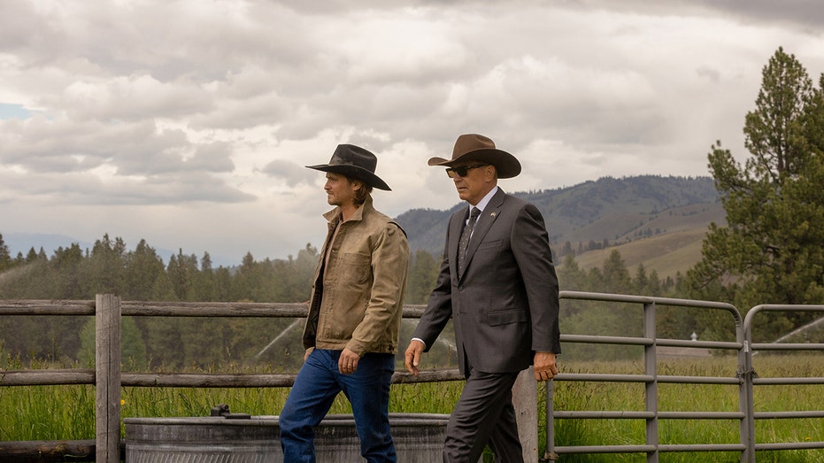 Kevin Costner walking with his co-star in beautiful scenery